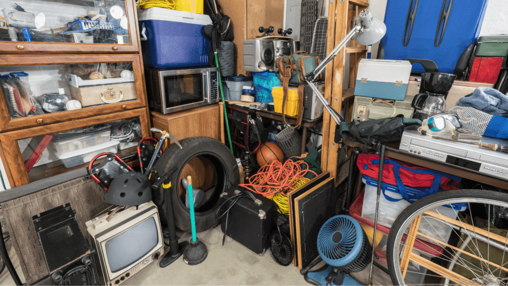Lots of household items randomly piled up and shoved in a corner, which depicts hoarding.