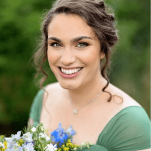 Volunteers Week: celebrating Suzy - smiling with a bouquet of flowers