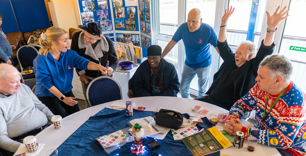 Group of people playing games and having fun indoors.